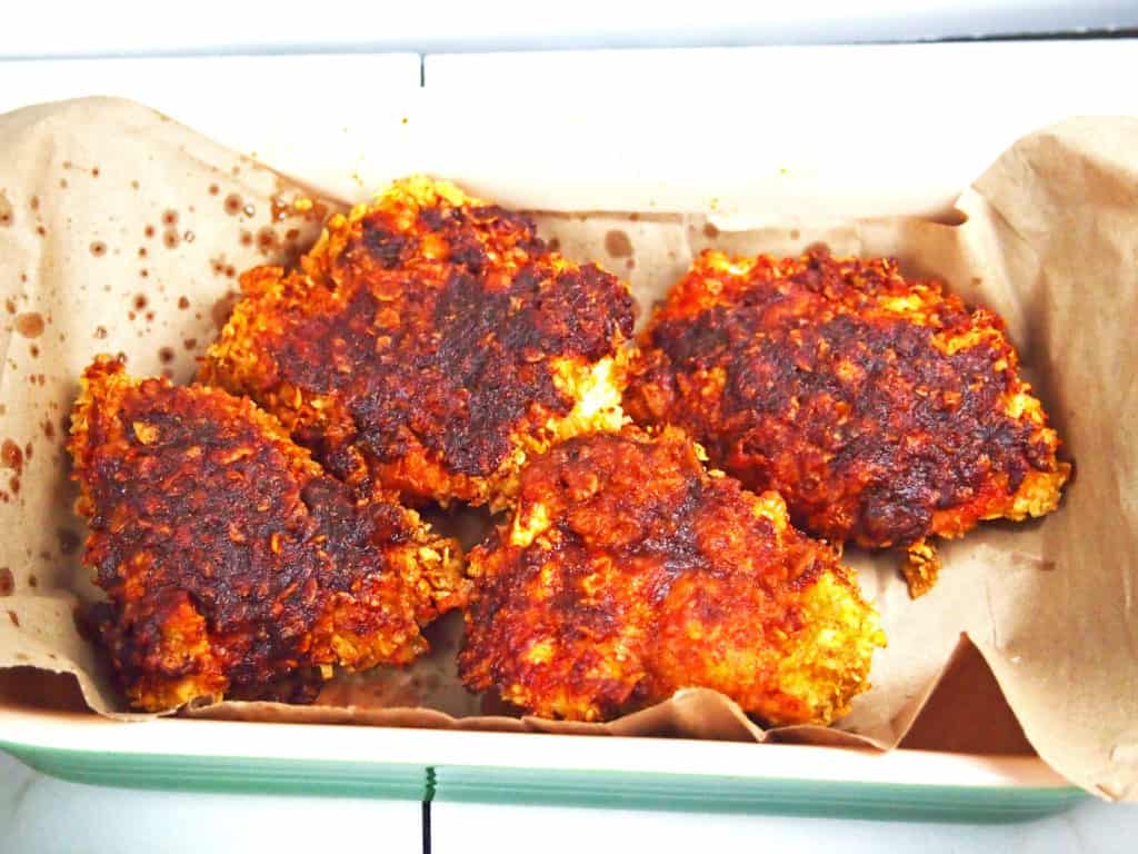 Oven fried, spicy chicken in a pan