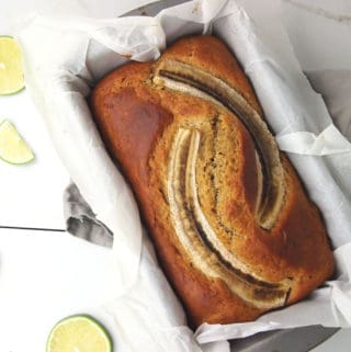 Banana bread with limes on a white background.