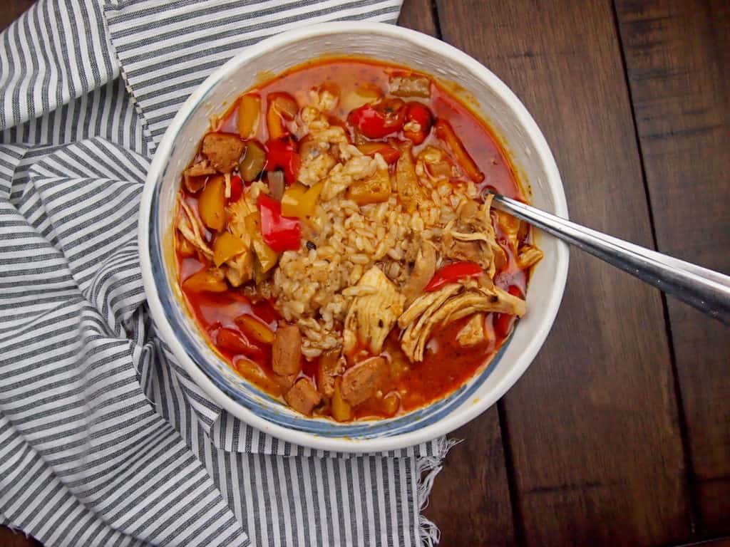 chicken gumbo with sausage and bell peppers with a spoon in the bowl