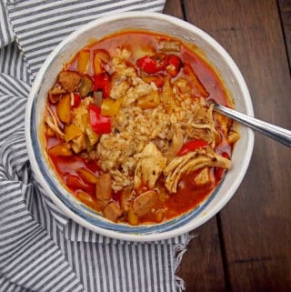 chicken gumbo with sausage and bell peppers with a spoon in the bowl