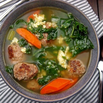 Italian wedding soup with meatballs, carrots, onions, and kale
