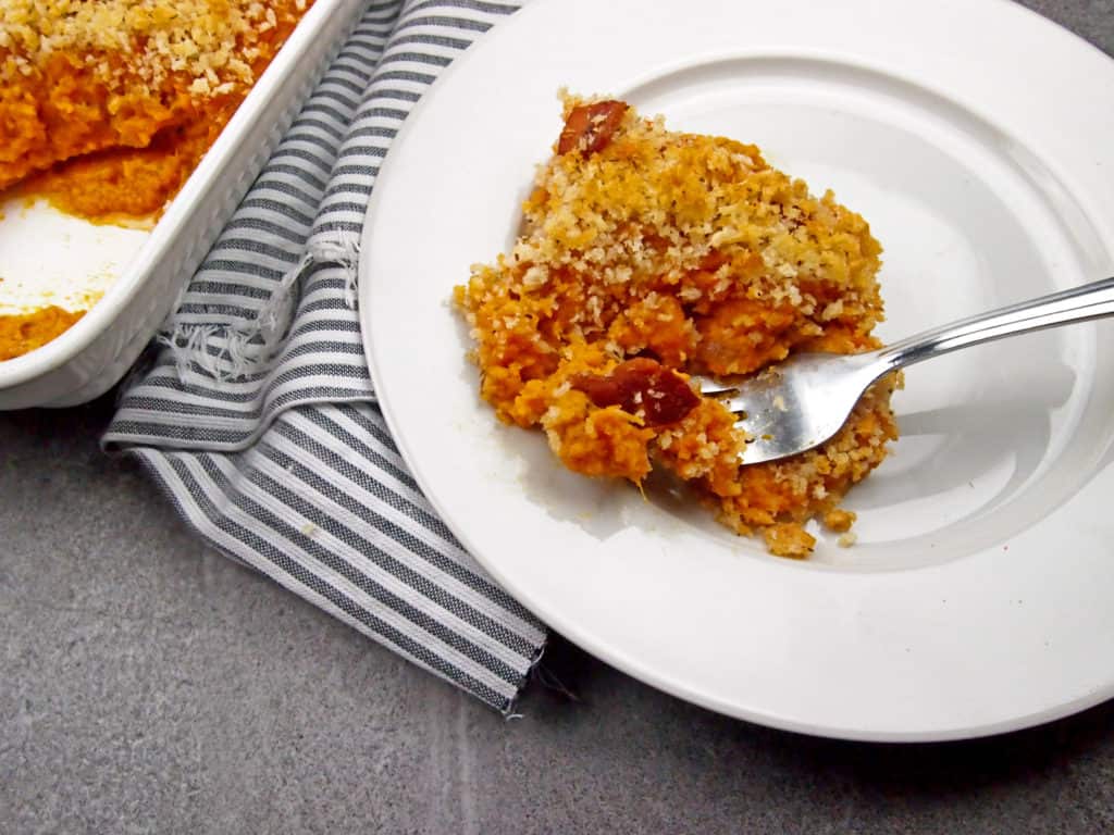 Close up of savory sweet potato casserole with bacon topping