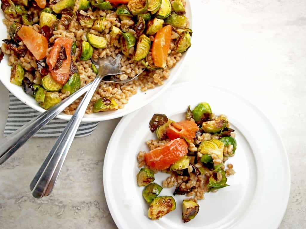 Overview of farro salad with brussels sprouts and citrus with some portioned on a plate