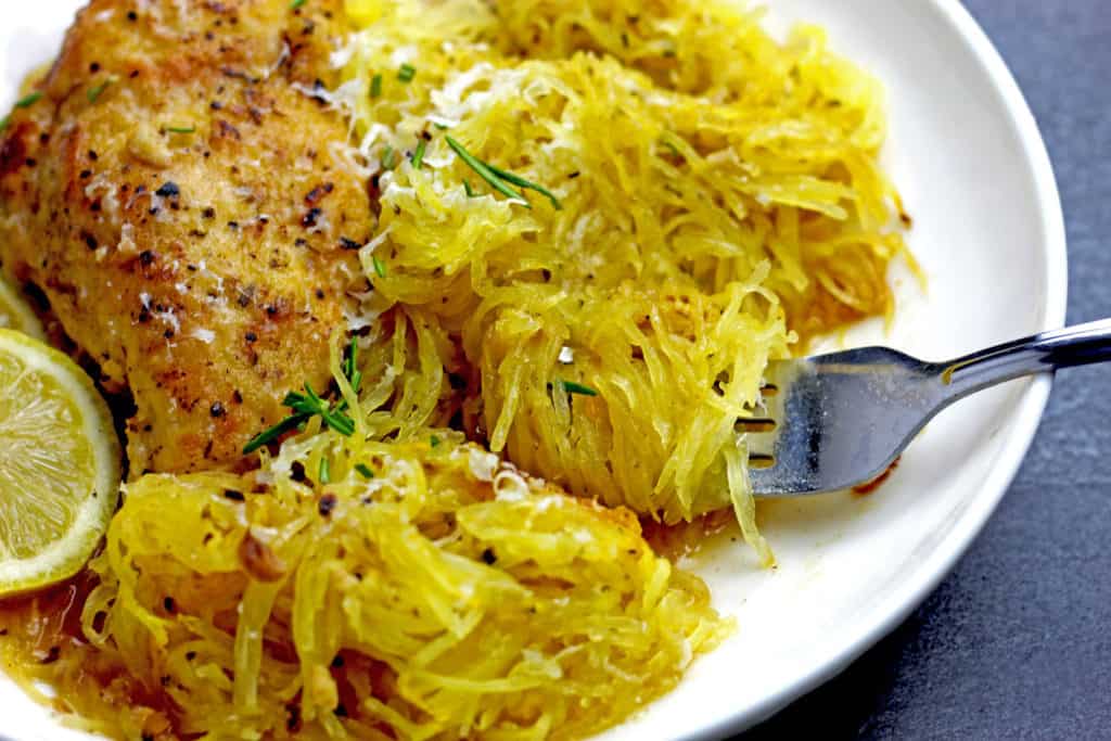 Close up of spaghetti squash being scooped up by a fork