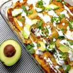 overview of smoked chicken enchiladas with avocado on the side