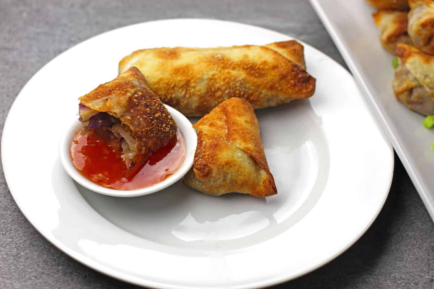 Egg roll broken and dipped into sauce