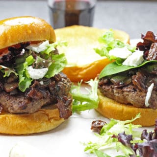 Burgers with onion, red wine, and bacon jam with spring mix and goat cheese