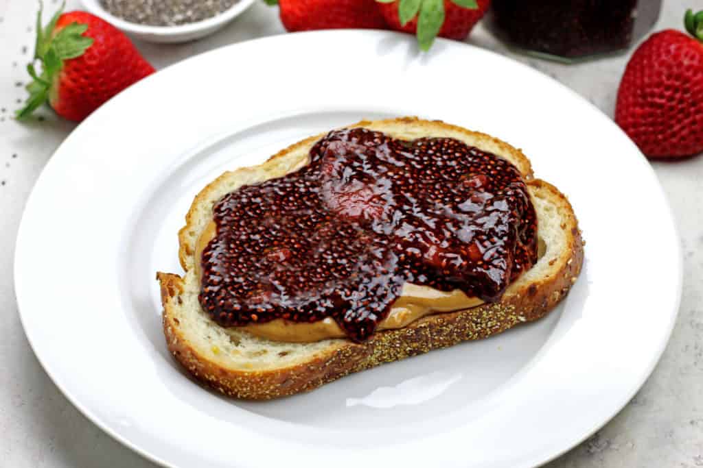 Strawberry chia jam on a piece of bread with peanut butter