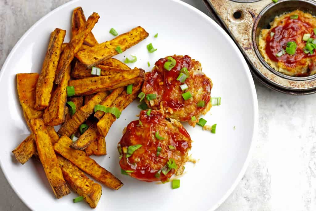 Mini Chicken Meatloaves with Pineapple BBQ Sauce on a plate with sweet potato fries