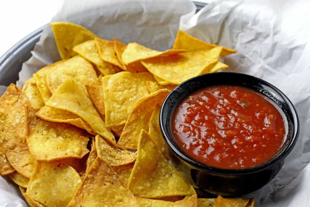 Basket of air fryer tortilla chips with salsa