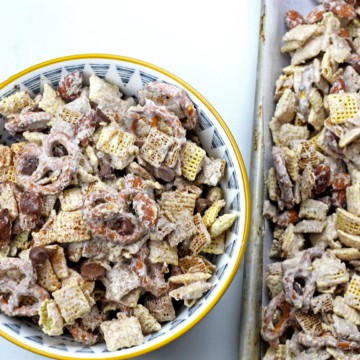 Bowl of churro chex mix next to a sheet pan of churro chex mix