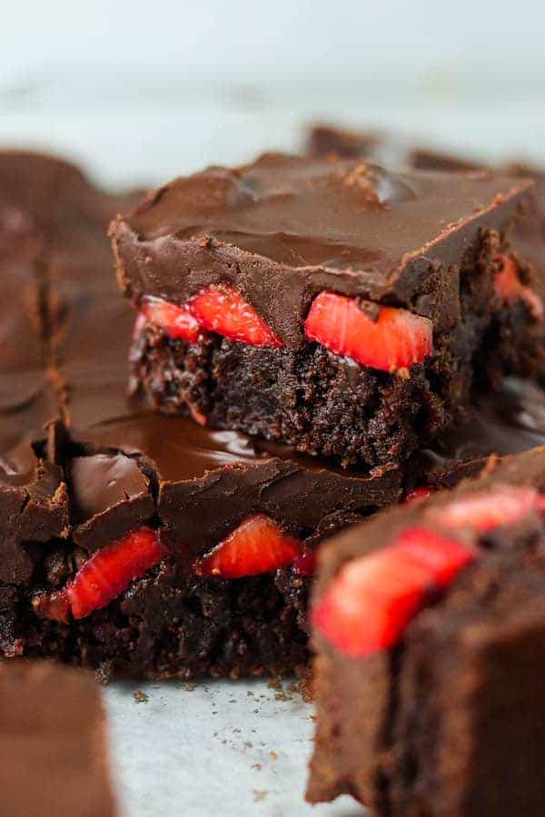 Chocolate brownies with strawberries inside.