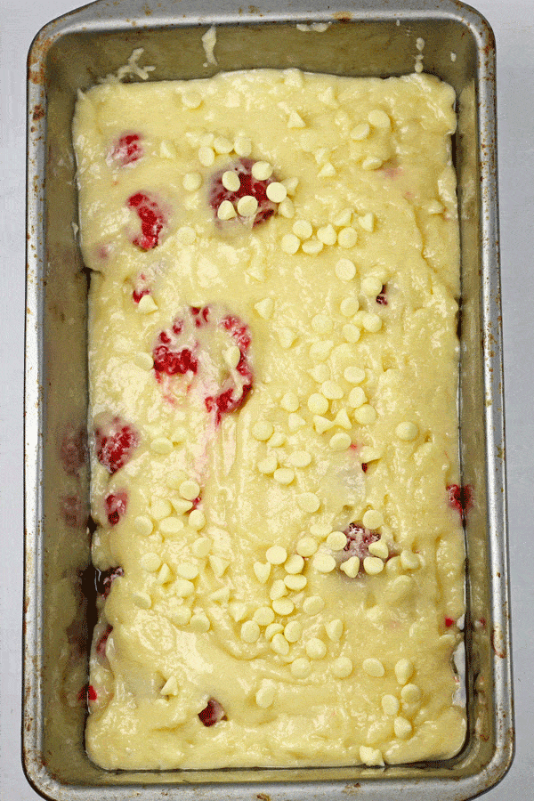 A loaf pan of the White Chocolate and Raspberry Loaf Cake batter.