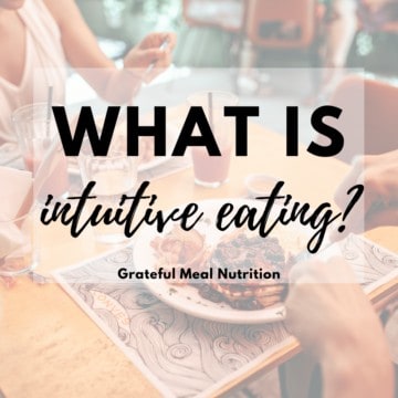 Picture of a plate of blueberries pancakes being eaten at a restaurant with cups of juice on the table with the words "what is intuitive eating?" and "grateful meal nutrition" in text overlay.