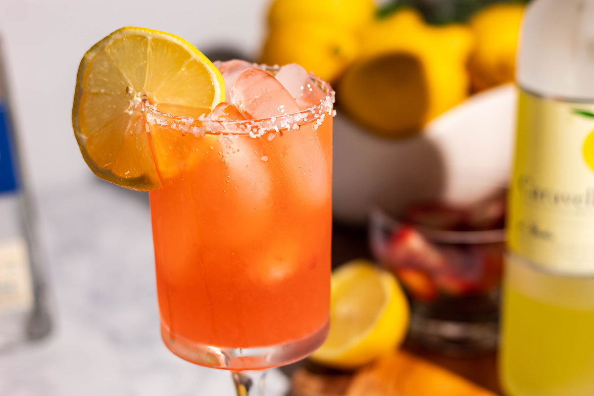 Strawberry limoncello margarita with a bowl of lemons in the background