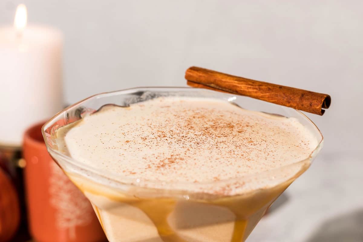 Close up of the top of the pumpkin mudslide that is garnished with a cinnamon stick and a dusting of pumpkin pie spice.