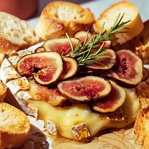 Fresh figs and rosemary on top of melted brie cheese.
