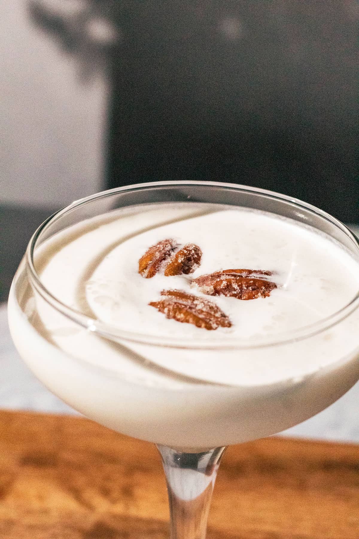 Pecan pie martini garnished with 3 candied pecans.