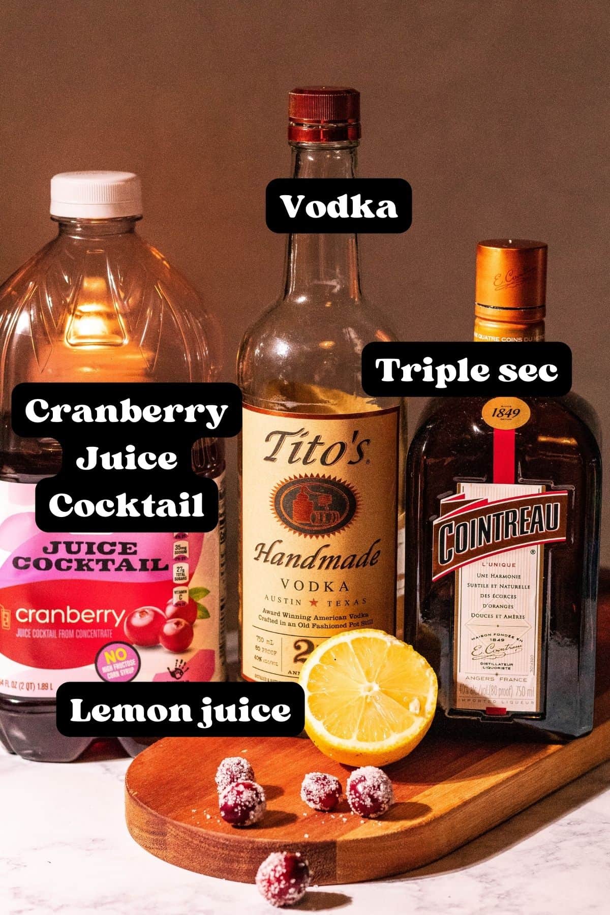 Ingredients for the martini shown including vodka, cranberry juice cocktail, lemon juice, and triple sec.