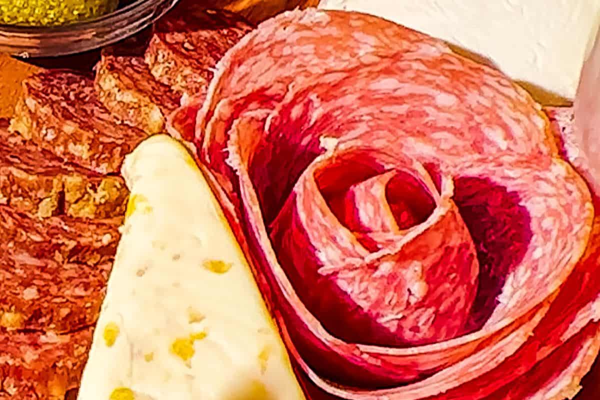 Salami rose with cheese and more charcuterie on the side.