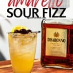 Pinterest image of cocktail with the words "best Amaretto sour fizz" in text overlay.