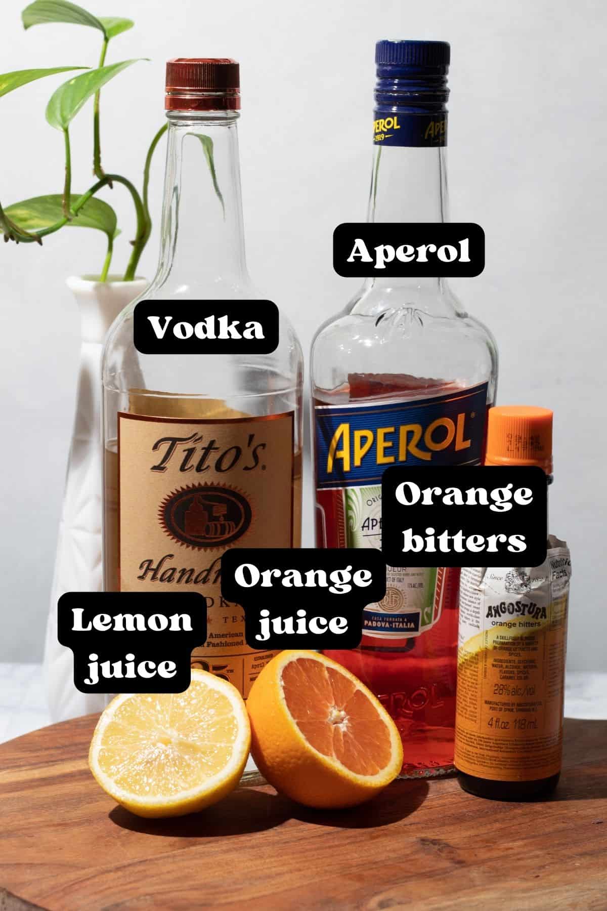 Ingredients for the cocktail spread out on a wood surface.
