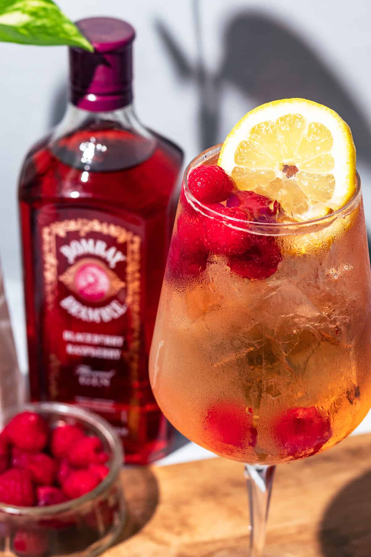 Spritz garnished with a lemon slice and raspberries.