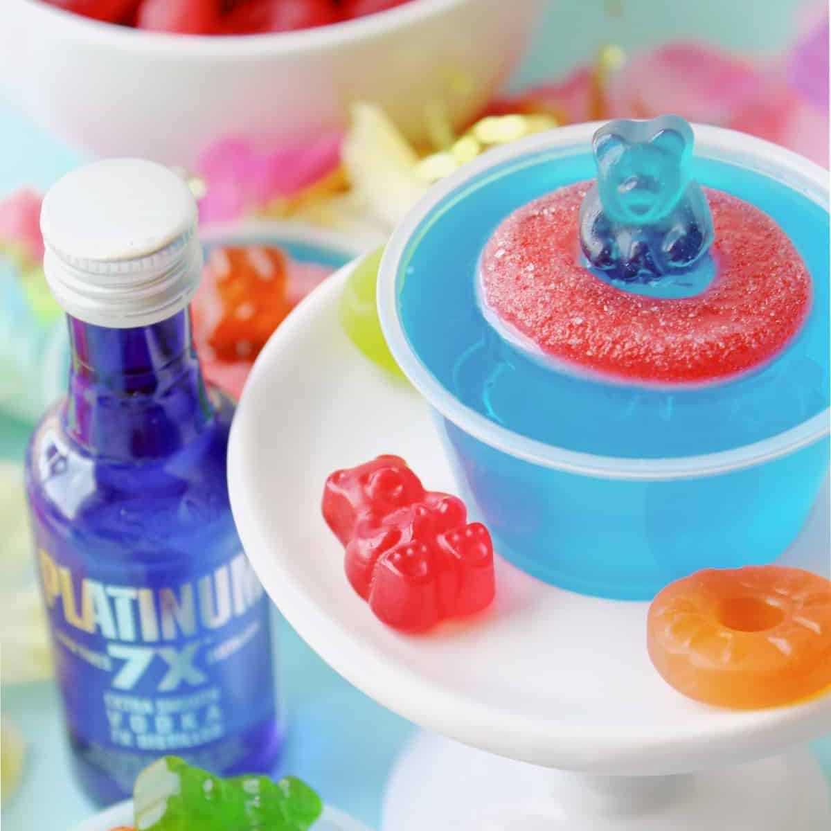 Jello shots with gummy candies on top.