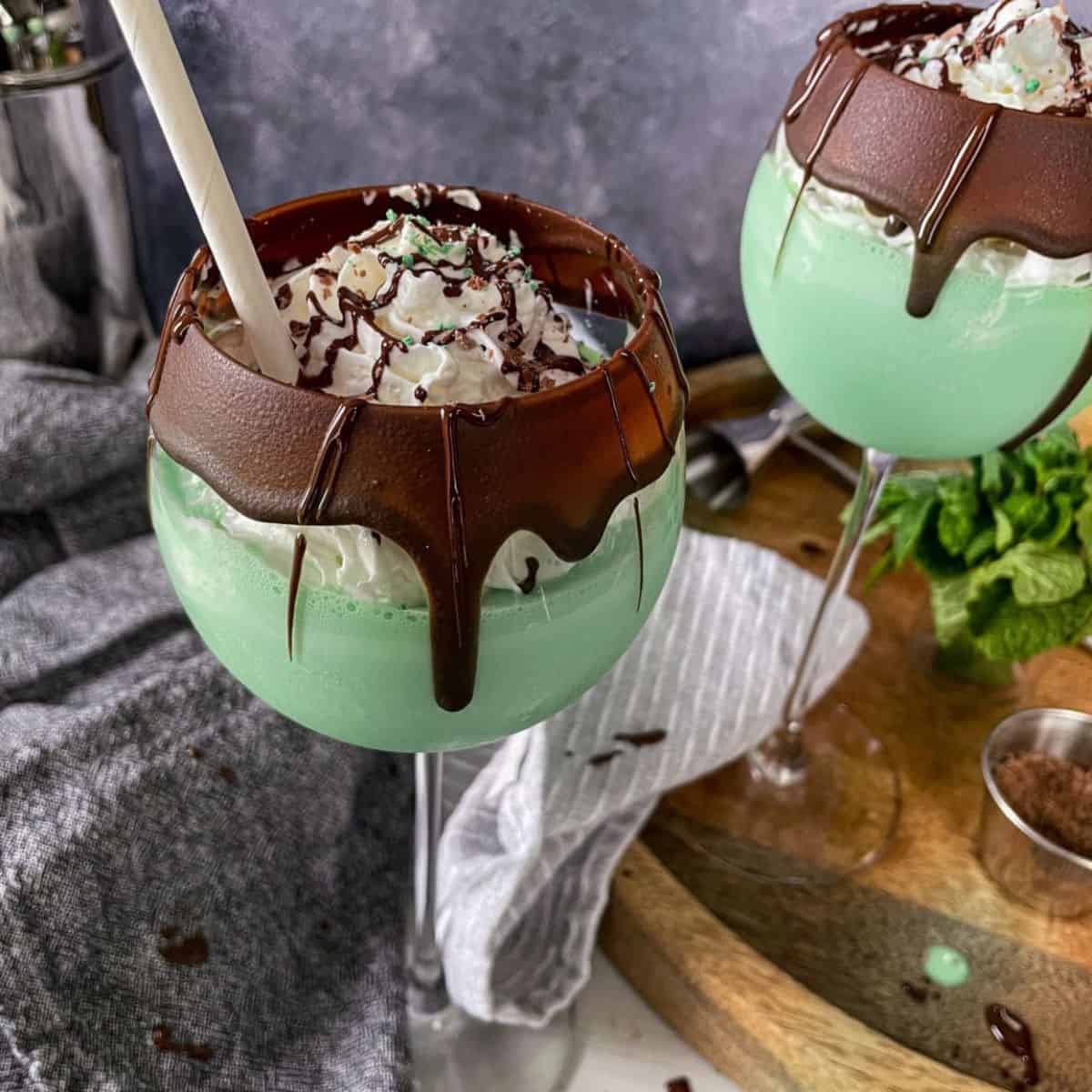 Grasshopper cocktail in a large wine glass with a chocolate coated rim.