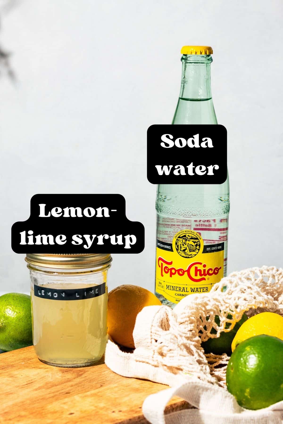 Ingredients for the soda spread out on a wood cutting board.