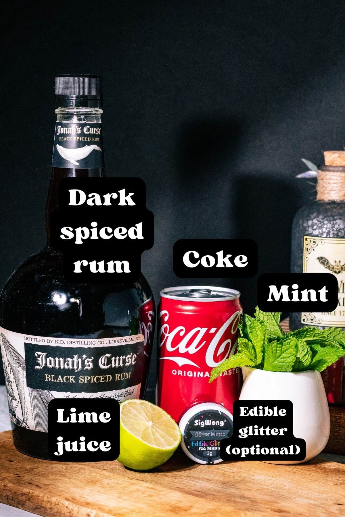 Ingredients for the cocktail spread out on a wood surface.