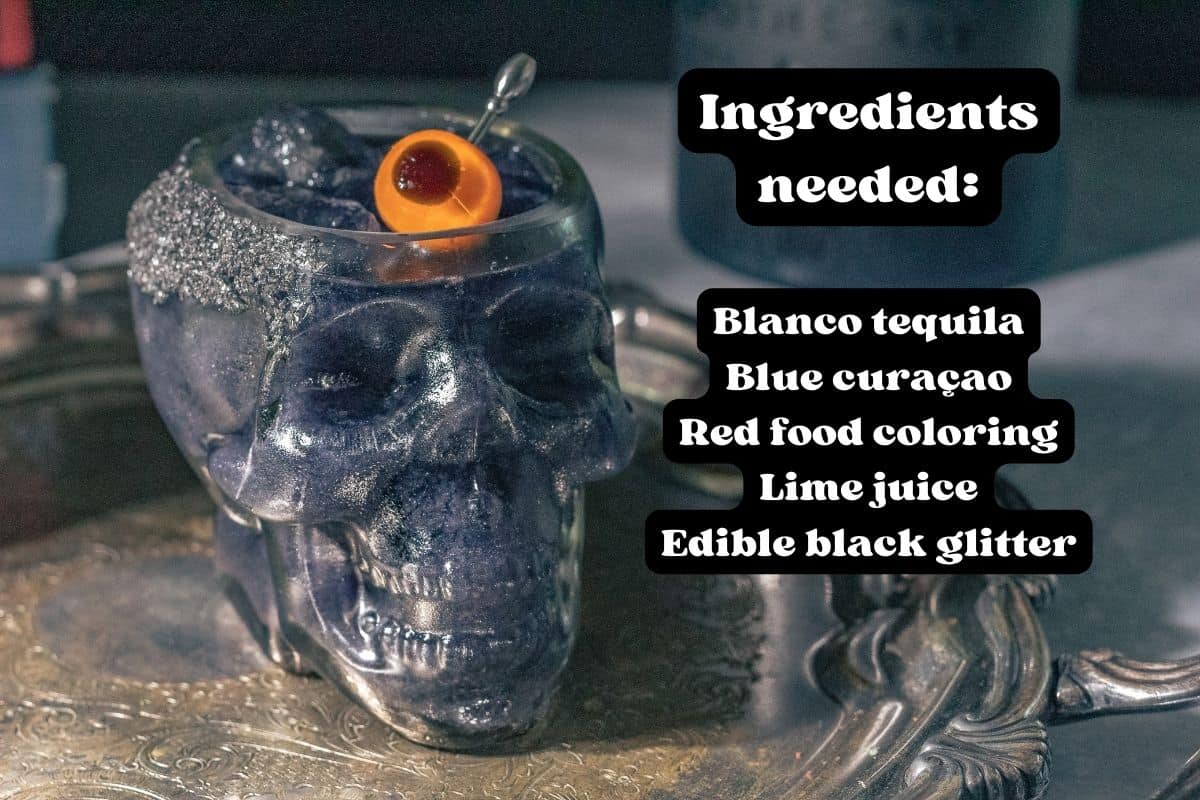 Black Magic Margarita in a skull cocktail glass on a silver platter listing each of the ingredients in text overlay. 