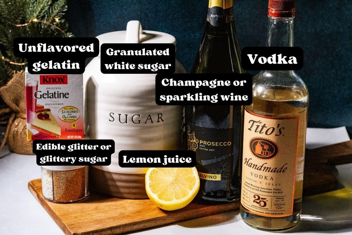 Ingredients for the jello shots spread out on a wood cutting board.