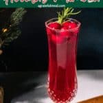 Pinterest image of the cocktail with the words "Poinsettia Holiday Mimosa" in text overlay.