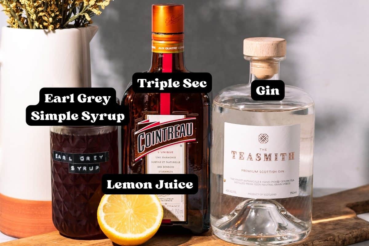 Ingredients for the cocktail on a wood surface.