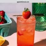 Pinterest image of the cocktail with the words "gin and tonic with strawberry" in text overlay.