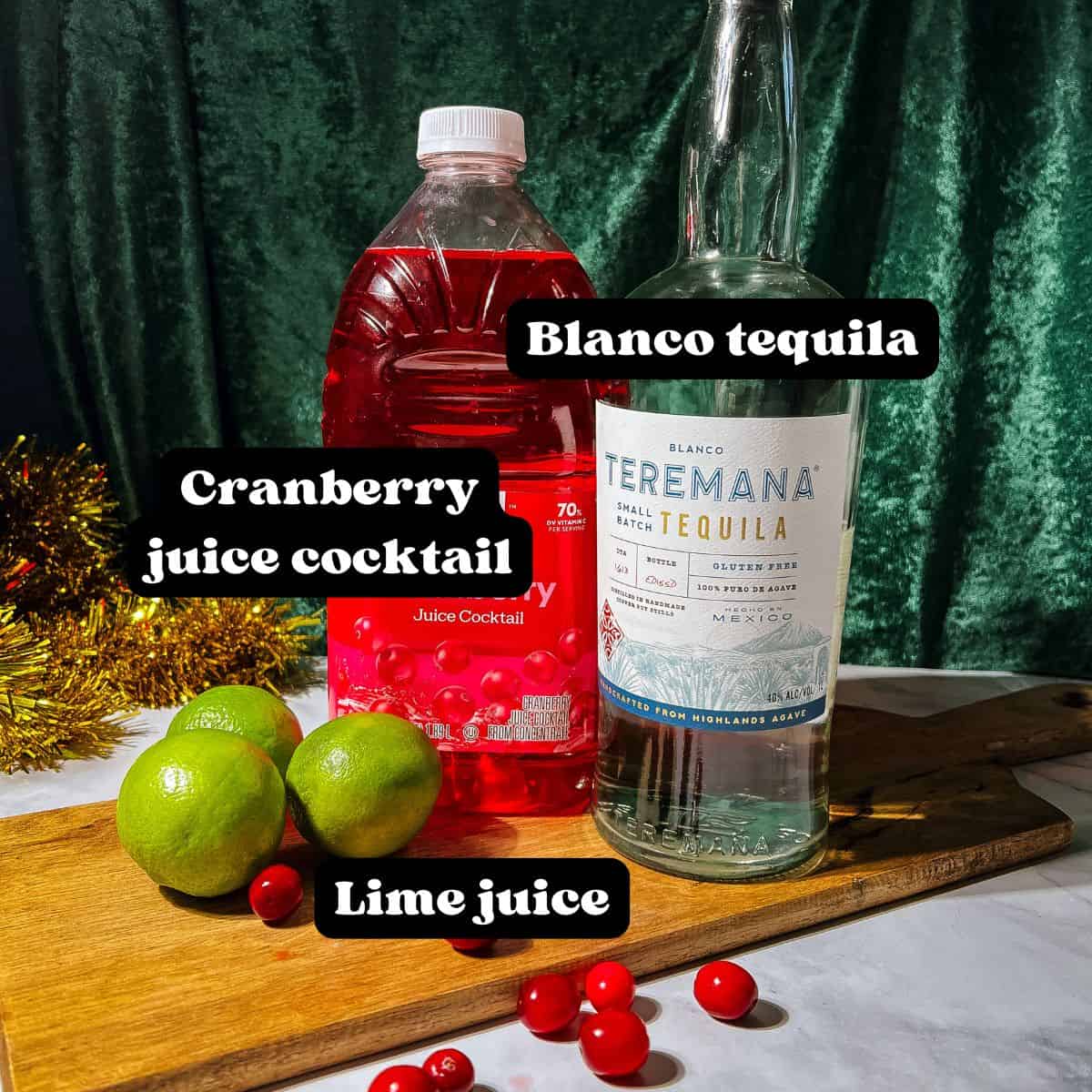 Ingredients for the margaritas spread out on a wood surface.