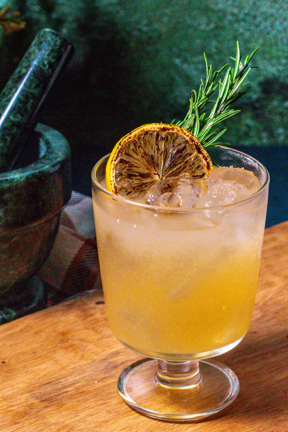 Fiery Cross cocktail on a wood surface.