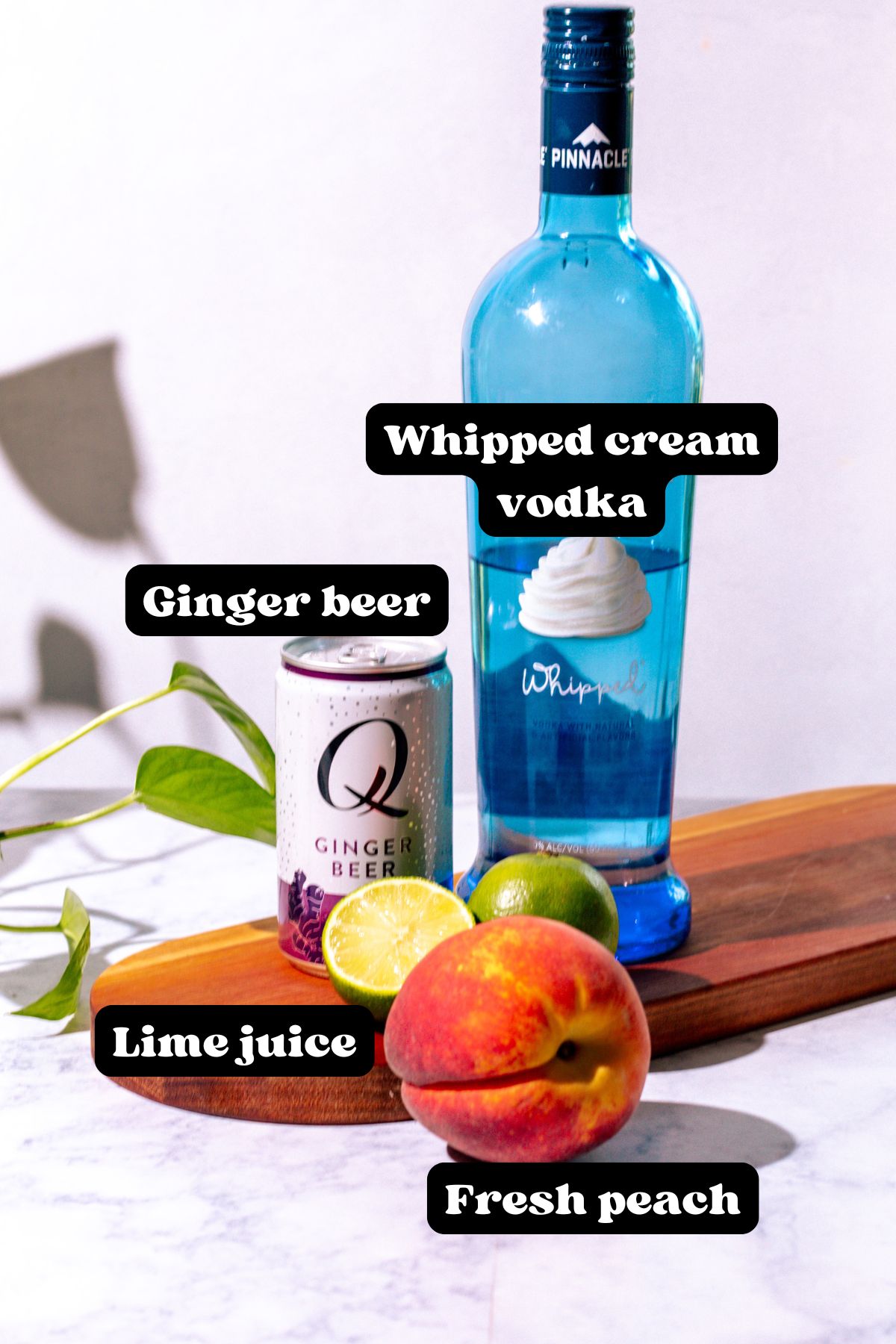 Ingredients for the cocktail laid out on a wood and marble surface.